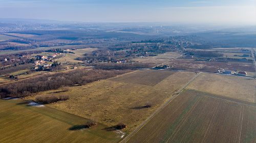 The 2 plots together are 19,998 square meters (1 + 1 hectare). 
Gas, water, electricity - these public utilities are available in the street, in front of the plot. The canalization of sewage water can be solved inside the boundaries of the plot. 